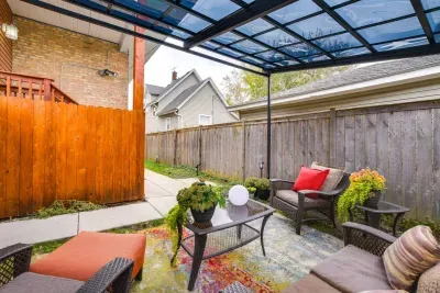 Outdoor Lounge: Sip your morning coffee in this vibrant retreat with cozy seating and lush greenery!