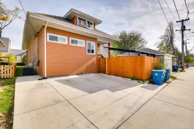 Exterior: Charming orange facade and spacious driveway—perfect for your next adventure!