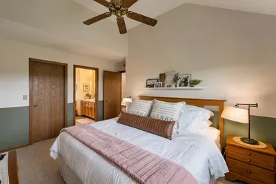 Upper-Level Bedroom: Bright retreat with fluffy bedding and stylish decor for your perfect getaway!