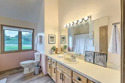 Upper Level Bathroom: Stylish retreat with a bright window and elegant decor for refreshing moments!
