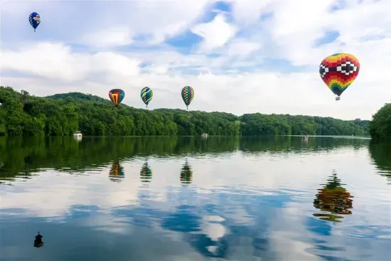Scenic Views: Soak in breathtaking hot air balloons over serene waters in Galena!