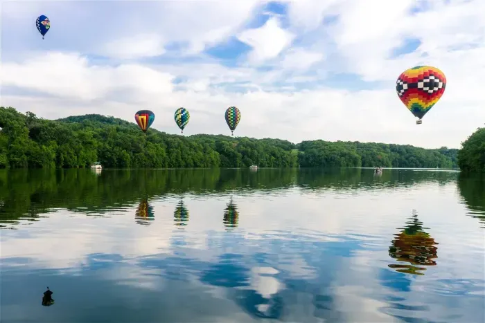 Scenic Views: Soak in breathtaking hot air balloons over serene waters in Galena!