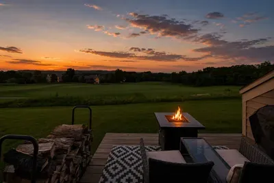 Gather around the fire pit table at dusk.