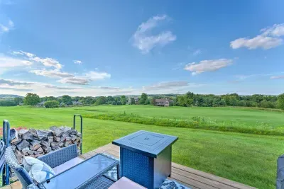 Patio Oasis: Relax and enjoy stunning views of lush golf course greenery from your private deck with fire pit table!