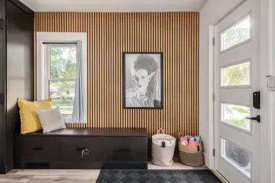 Entryway Retreat: Stylish wood accents and vibrant art greet you in this inviting, sunlit space!