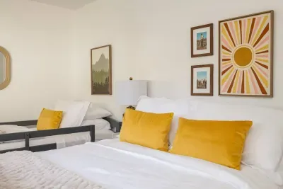 Bedroom Retreat: Vibrant decor and plush bedding invite you to relax in style and comfort!