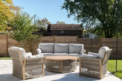 Charming Entryway: Relax on the patio with dappled sunlight amidst lush greenery!