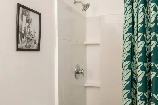 Bathroom Bliss: Refresh in this sleek shower with stylish tropical accents!