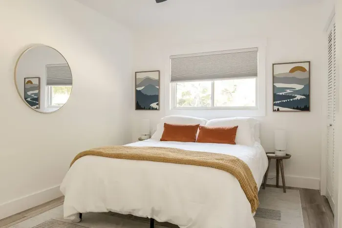 Bedroom Retreat: Bright and airy space with nature-inspired decor and scenic window views!