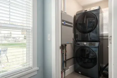 Laundry Closet: Enjoy the convenience of modern appliances and a sunny view while you wash!