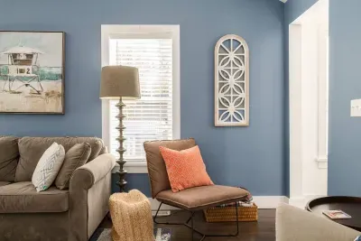 Living Room: Bright blue walls and stylish decor invite relaxation and fun in this vibrant retreat!