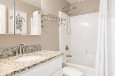 Modern Bathroom: Elegant design with granite countertops and a relaxing tub for post-adventure unwinding!