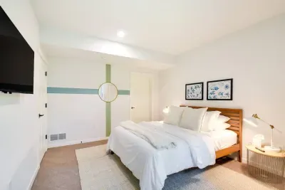 Dreamy Queen Bedroom Retreat: Sunlit space with chic decor and plush bedding for ultimate relaxation!