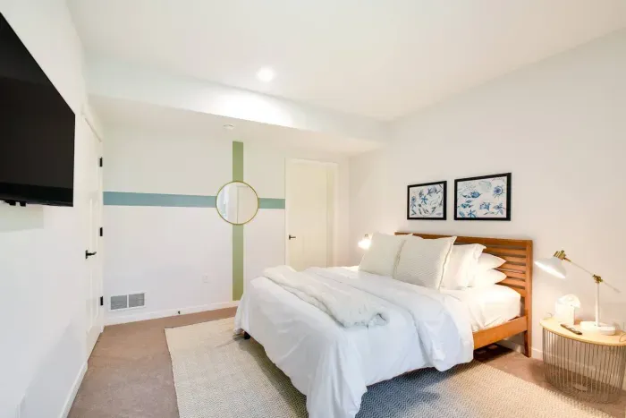 Dreamy Queen Bedroom Retreat: Sunlit space with chic decor and plush bedding for ultimate relaxation!