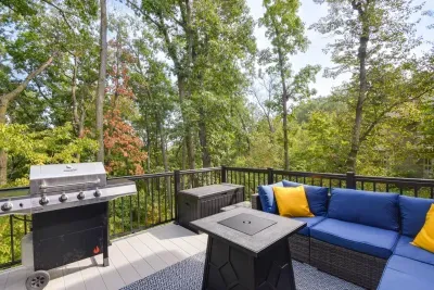 Outdoor Lounge: Sizzle on the grill and unwind with nature views from this stunning balcony in the woods!