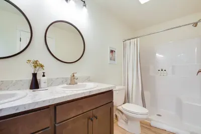 Elegant Bathroom: Bright space with dual sinks, walk-in shower, modern fixtures, and stylish decor for a refreshing retreat!