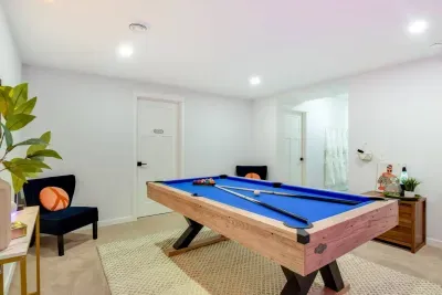 Game Room: Perfect your shot on the vibrant blue pool table in this stylish gaming retreat!