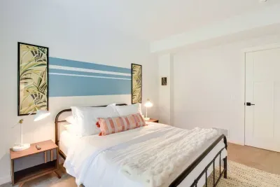 Queen Retreat: Enjoy restful nights in this stylish room with vibrant decor and soft lighting!