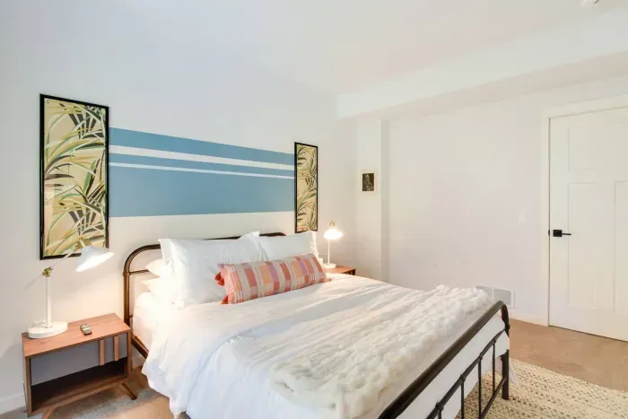 Queen Retreat: Enjoy restful nights in this stylish room with vibrant decor and soft lighting!