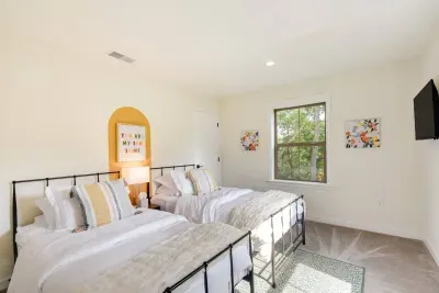 Twin Room: Bright and airy retreat featuring stylish beds and lovely views of nature!