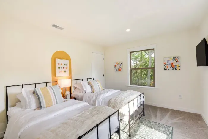 Twin Room: Bright and airy retreat featuring stylish beds and lovely views of nature!