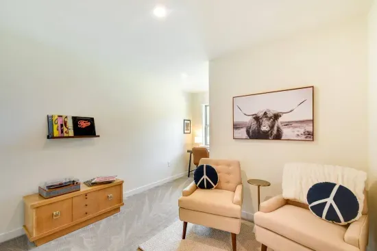 Charming Landing: Relax and unwind in a bright space with quirky decor, inviting seating & vintage vinyl!