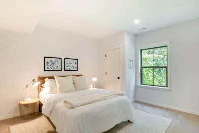 Serene Queen Retreat: Bright and airy bedroom with nature views and stylish decor invites relaxation!