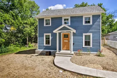 Exterior Delight: Charming blue facade with inviting porch, surrounded by nature's beauty yet steps from Main Street!