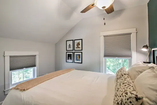 Charming Queen Bedroom: Bright space with artwork, comfy bed, and lovely views for a perfect retreat!