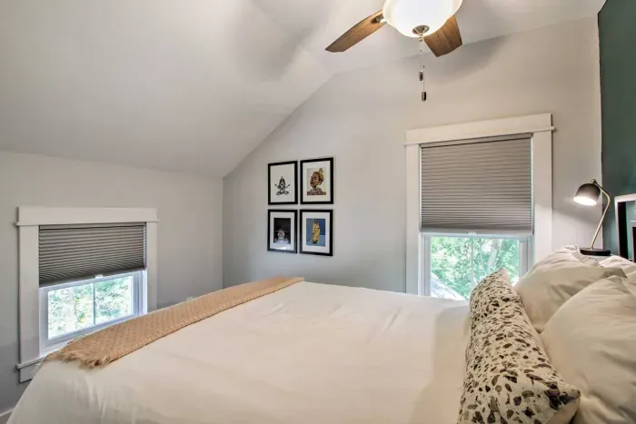 Charming Queen Bedroom: Bright space with artwork, comfy bed, and lovely views for a perfect retreat!