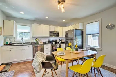 Kitchen: Bright and airy space with modern appliances and cheerful yellow dining chairs!