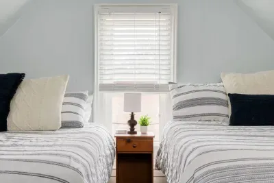 Twin Bedroom: Bright and airy retreat with plush bedding and a sweet window view!
