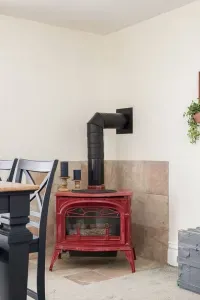 Living Room: Enjoy gatherings by the stylish red stove, perfect for warm, inviting moments together!