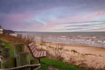 Scenic Beachfront Retreat: Relax on the bench with stunning lake views and sunset hues!