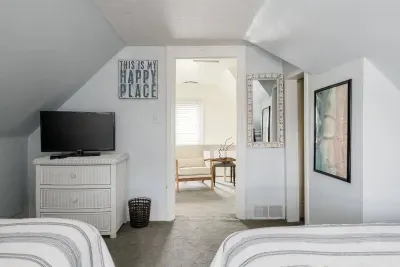 Guest Room: Relax in this bright space with comfy beds and easy access to the lounge area!