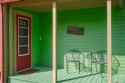 Charming Porch: Sip morning coffee surrounded by vibrant colors and lakefront vibes!