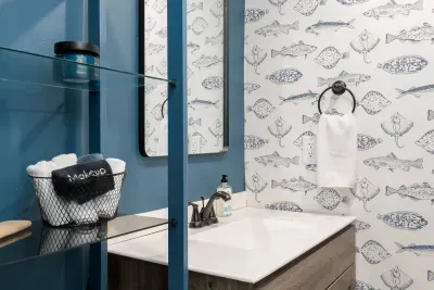 Bathroom Retreat: Bright blue walls and fish-themed decor create a playful, refreshing vibe!