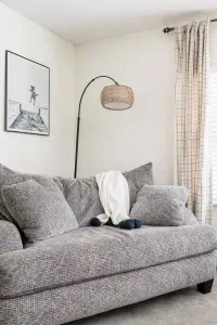 Living Room: Relax on a plush sofa, illuminated by stylish lighting and adorned with beachy décor!