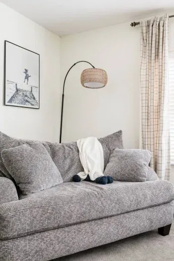 Living Room: Relax on a plush sofa, illuminated by stylish lighting and adorned with beachy décor!