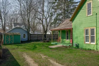 Exterior: Vibrant green façade and inviting porch, perfect for summer relaxation in the sun!