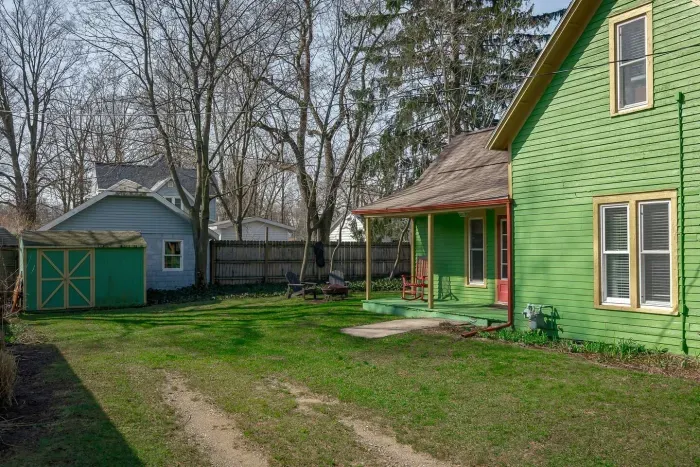 Exterior: Vibrant green façade and inviting porch, perfect for summer relaxation in the sun!
