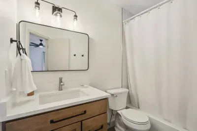 Modern Bathroom Retreat: Experience sleek decor with a stylish vanity and refreshing shower!
