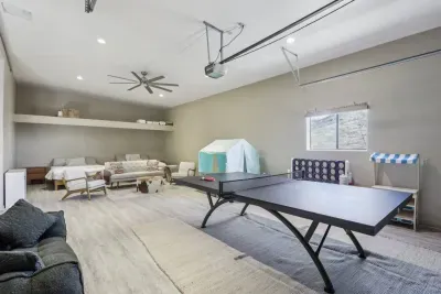Game Room: Unwind with fun activities, featuring a ping pong table and relaxing seating!