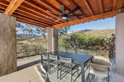 Outdoor Dining Oasis: Savor meals with mountain views under a stunning wood-beamed patio!