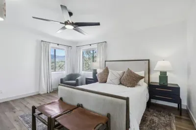 Queen Bedroom Oasis: Sunlit retreat with stunning views, modern decor, and a tranquil ambiance awaits!