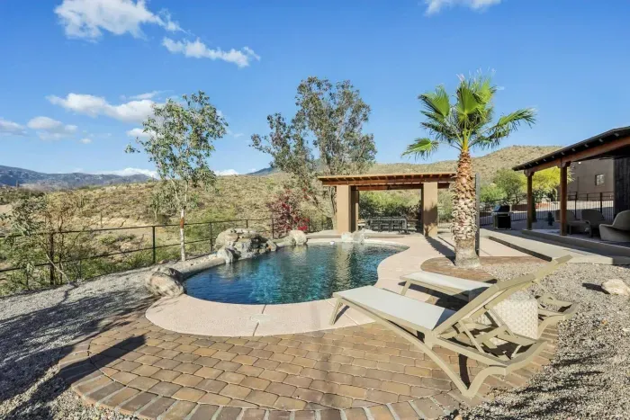 Outdoor Oasis: Refreshing pool with mountain views and lounge chairs for sun-soaked relaxation!