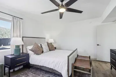 Queen Bedroom Retreat: Bright space with mountain views, plush bedding, and sleek decor awaits!