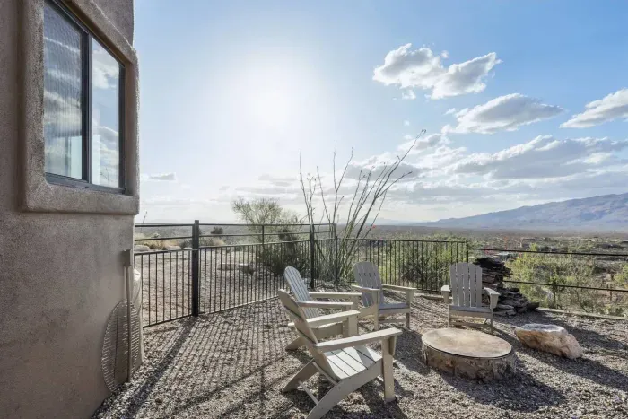 Outdoor Lounge: Enjoy breathtaking views while relaxing by the fire pit in this serene space!
