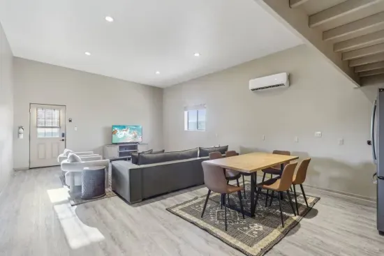 Guest House Living Room: Bright and airy space with stylish furniture and AC, perfect for relaxation or dining!