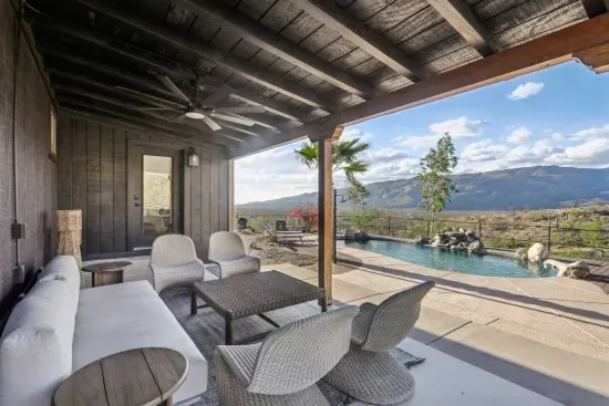 Patio Escape: Unwind poolside with stunning mountain views from this stylish outdoor lounge!